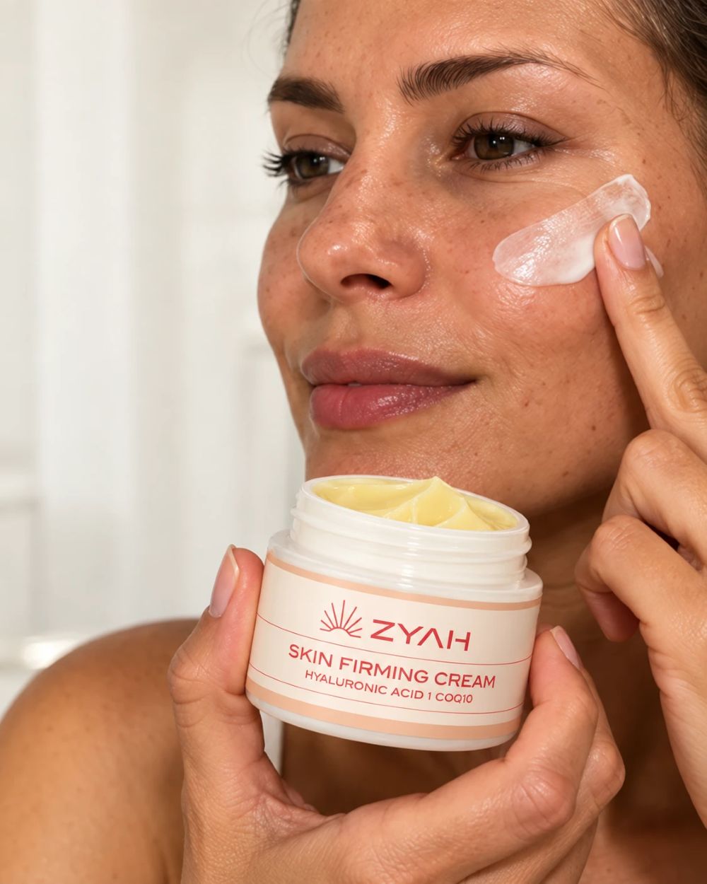 Model applying ZYAH Skin Firming Cream